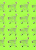 Shopping addiction, shopping lover or shopaholic concept. Many small empty shopping carts perform a pattern on a pastel colored paper background. Flat lay composition, top view photo