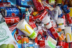 KHARKOV, UKRAINE - JULY 2, 2021 Many wrappings and cans from used products by famous worldwide brands. Pattern of trash of various colors and materials photo