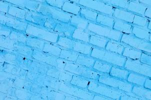 Square brick block wall background and texture. Painted in blue photo