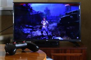 KHARKOV, UKRAINE - NOVEMBER 12, 2020 Video game controller Gamesir g3s on table with Metro Exodus game on display photo