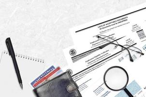 USCIS form I-9 Employment eligibility verification lies on flat lay office table and ready to fill. U.S. Citizenship and Immigration services paperwork concept photo