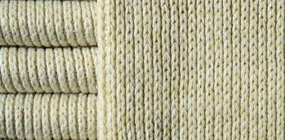 Composition of a soft yellow knitted sweater. Macro texture of bindings in yarns photo