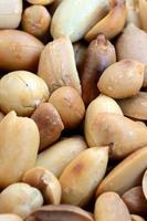 Peanut. A lot of small yellow nuts without peel. Background texture photo