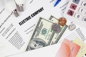 Abstract American electricity bill. Concept of saving money by using energy savings led light bulbs and electric bill payment photo