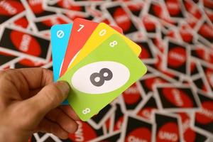 TERNOPIL, UKRAINE - MAY 15, 2022 Many colorful UNO game cards. UNO is an American shedding-type card game that is played with a specially printed deck photo