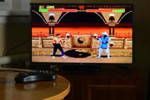 KHARKOV, UKRAINE - NOVEMBER 12, 2020 Sega mega drive video game controller on table with Mortal Kombat 2 game on display photo