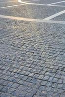 Fragment of the street square, folded out of a gray square paving stone photo