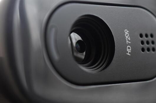 A modern web camera is installed on the body of a flat screen monitor. Device for video communication and recording of high quality video photo