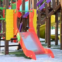 Fragment of a playground made of plastic and wood, painted in different colors photo