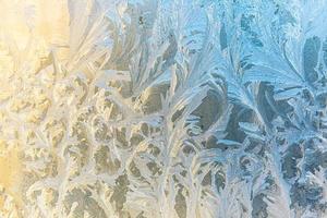 Frozen winter window with shiny ice frost pattern texture. Christmas wonder symbol, abstract background. Extreme north low temperature, natural Ice snow on frosty glass, cool winter weather outdoor. photo