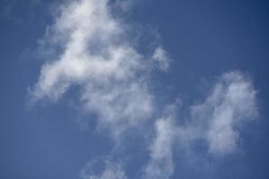 Blue clear sky with white feathery clouds. photo