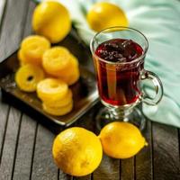 Creative layout made of cup of hibiscus tea and lemon on a table background. Top view. photo