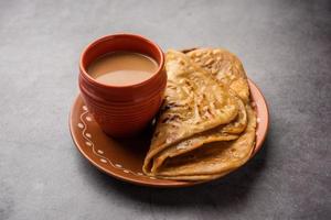 chai paratha: el té caliente servido con pan plano es una comida tradicional sencilla de india y pakistán foto