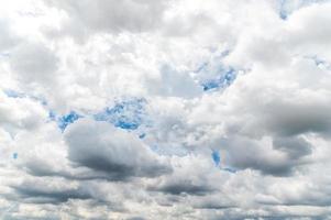 Storm clouds floating in a rainy day with natural light. Cloudscape scenery, overcast weather above blue sky. White and grey cloud scenic nature environment background photo