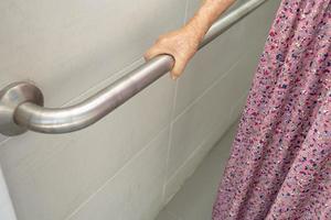 Asian senior or elderly old lady woman patient use toilet bathroom handle security in nursing hospital ward, healthy strong medical concept. photo