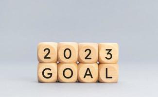 2023 GOAL message on wooden cube blocks on gray background. Resolution, strategy, plan New Year. Copy space photo