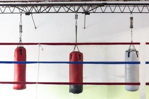 boxing gym with hanging bags, black and white sports photography photo