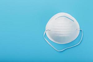 Round face mask on a blue background. Virus protection Isolate photo