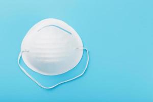 Round face mask on a blue background. Virus protection Isolate photo