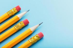 Orange pencils with an eraser on a blue background.