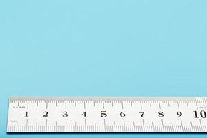 A metal ruler with a scale on a blue background is a superscape with a copy of the space for your text. photo