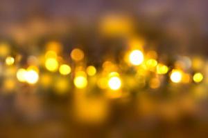Blurred lights of bulbs on dark background. Defocused. Christmas, New Year, holiday photo