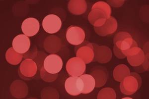 Defocused lights. Red bokeh on black background. Christmas and New year overlay. Copy space photo