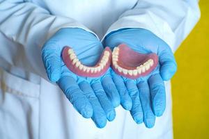 dentures in the hands of a dental technician photo