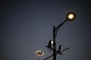 Pole with lamp in city. City light. Outdoor lighting fixture. photo