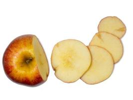 A large red apple cut into wedges. Fresh fruit isolate. photo