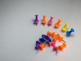 colored memothumb tacks. Stationery on white background. photo