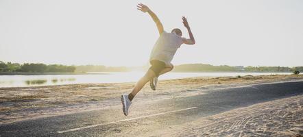 The silhouette of a man running is exercising the evening. photo