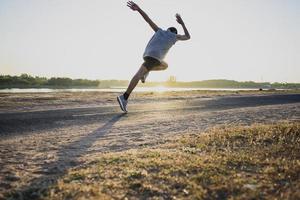 The silhouette of a man running is exercising the evening. photo