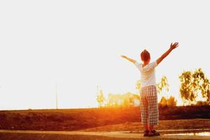 Happy traveler man with a successful emotion by raise two arms over her head. Cheering successful woman hiker open arms on mountain top. Tourism, traveling and healthy lifestyle concept. photo