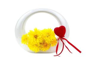 Yellow chrysanthemum flowers in round vase with red heart on white isolated background. Valentine's, Mother's, International Women's Day, Birthday. Copy space photo