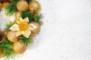 Shiny yellow Christmas balls and cone with barks and pine branches on white background. New year card photo