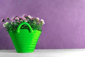 Bouquet of small chrysanthemums in green vase on lilac background. Floral and holiday card. Copy space photo