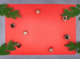 Spruce branches with golden cones and nuts with green spruce branches on red background and stripes. Christmas, New Year Copy space photo