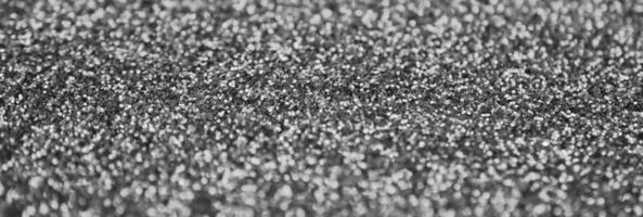 Silver decorative sequins. Background image with shiny bokeh lights from small elements photo