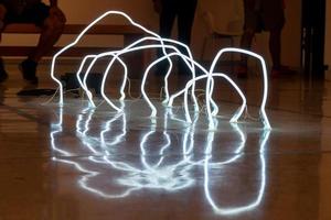 leds on the floor arranged in irregular arcs, reflections on the polished floor photo
