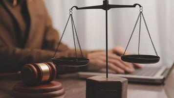 Justice and law concept.Male judge in a courtroom with the gavel, working with, computer and docking keyboard, eyeglasses, on table in morning light video
