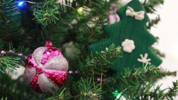 en krans blinkar på ett artificiell jul träd dekorerad med leksaker och ballonger. video