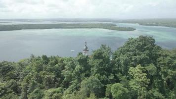aereo Visualizza di Gesù statua con bellissimo spiaggia Visualizza nel piccolo isola. maluku, Indonesia - luglio, 2022 video