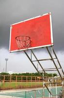 old outdoor basketball hoop agains photo