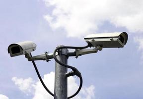 security cameras in front of blue sky photo