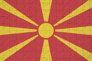 Macedonia flag  is depicted on a folded puzzle photo