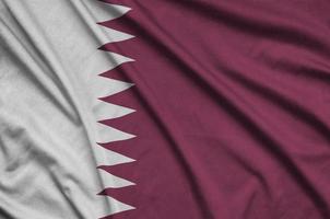 Qatar flag  is depicted on a sports cloth fabric with many folds. Sport team banner photo