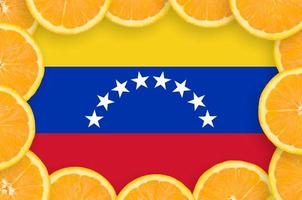 Venezuela flag  in fresh citrus fruit slices frame photo