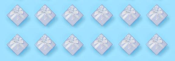 A lot of blue gift boxes lies on texture background of fashion pastel blue color paper in minimal concept photo