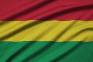 Bolivia flag  is depicted on a sports cloth fabric with many folds. Sport team banner photo